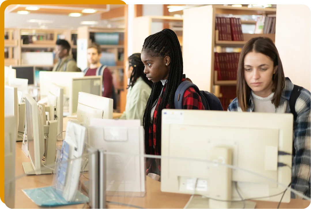 Students working at library computers